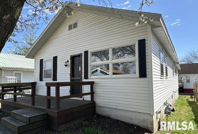 back of house featuring a deck