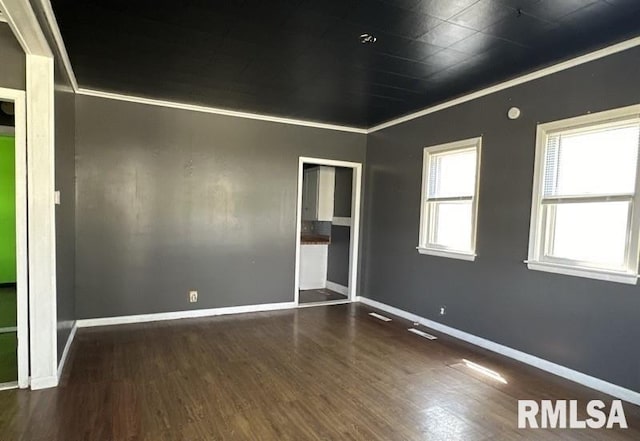 empty room with ornamental molding, ceiling fan, and dark hardwood / wood-style floors