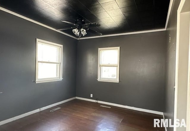 spare room with ceiling fan, dark hardwood / wood-style floors, and ornamental molding