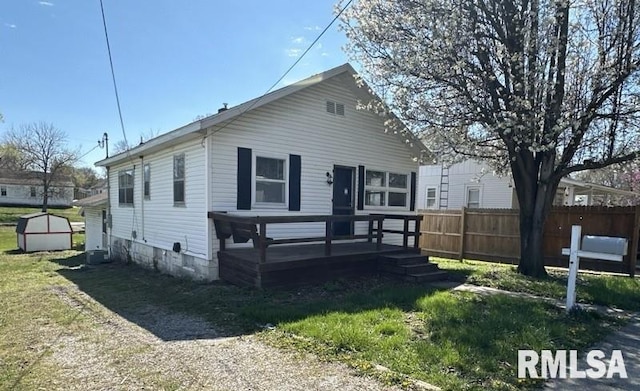 rear view of property with a yard and a wooden deck