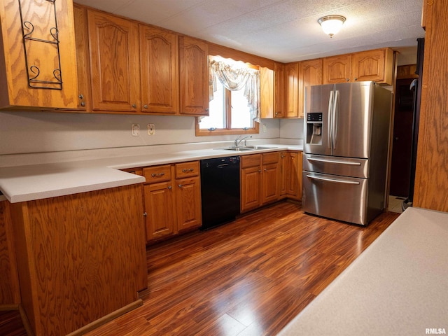 kitchen with black dishwasher, sink, dark hardwood / wood-style floors, and stainless steel refrigerator with ice dispenser