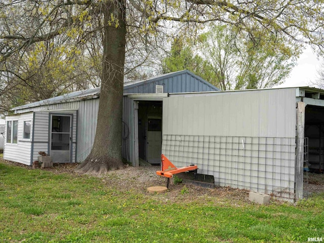 view of outbuilding featuring a lawn