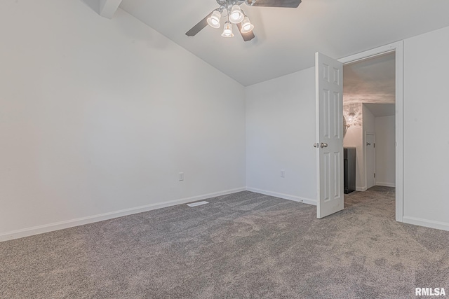 spare room featuring lofted ceiling with beams, ceiling fan, and carpet floors