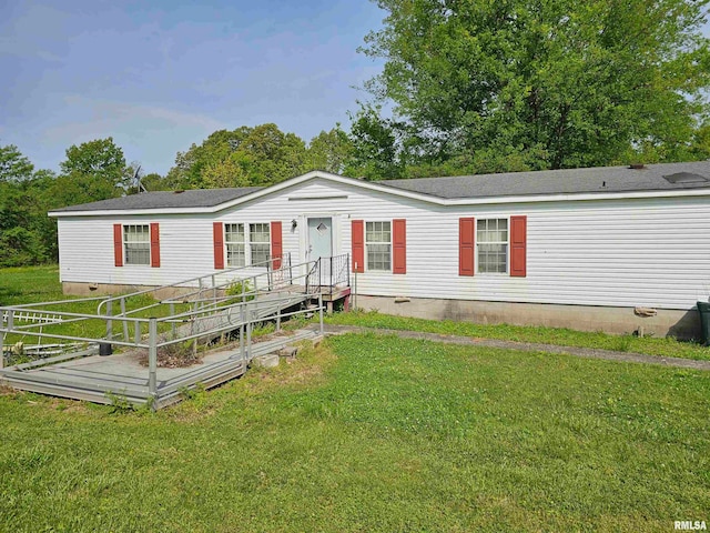 manufactured / mobile home with a front yard and a wooden deck