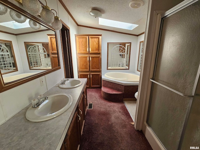 full bathroom featuring double sink vanity, lofted ceiling with skylight, toilet, a textured ceiling, and plus walk in shower