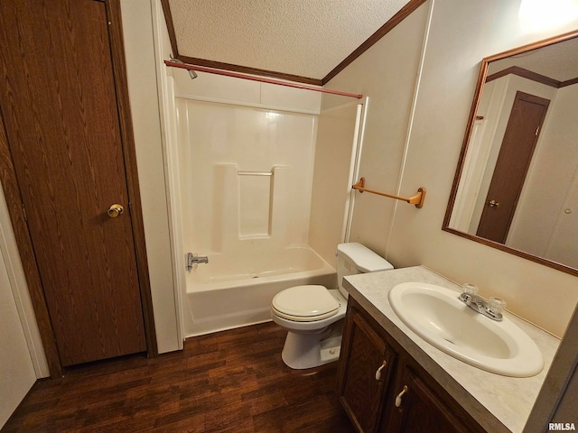 full bathroom featuring vanity, hardwood / wood-style floors, shower / bath combination, toilet, and a textured ceiling