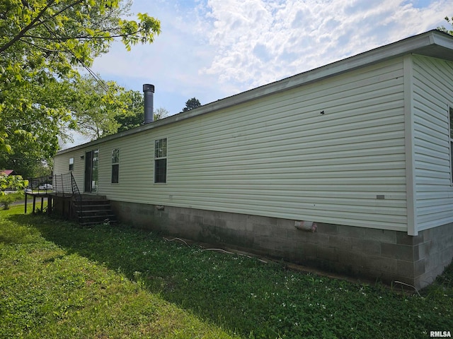 view of property exterior with a yard