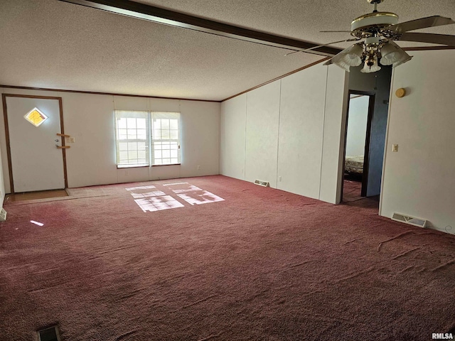 unfurnished room with ceiling fan, carpet floors, and a textured ceiling