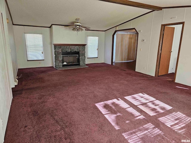 unfurnished living room with dark colored carpet, plenty of natural light, and a textured ceiling