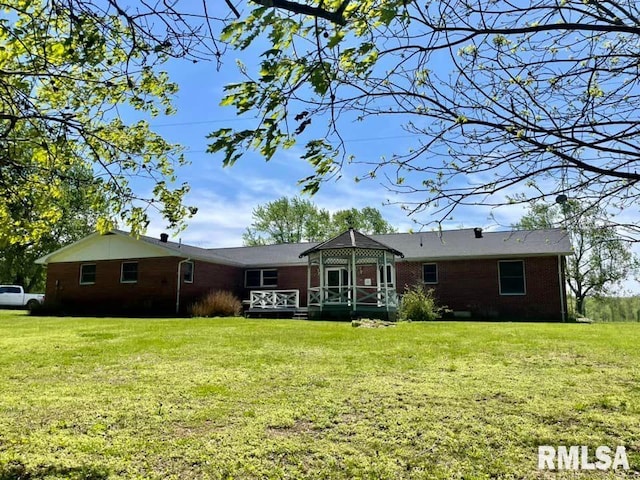 back of house with a yard