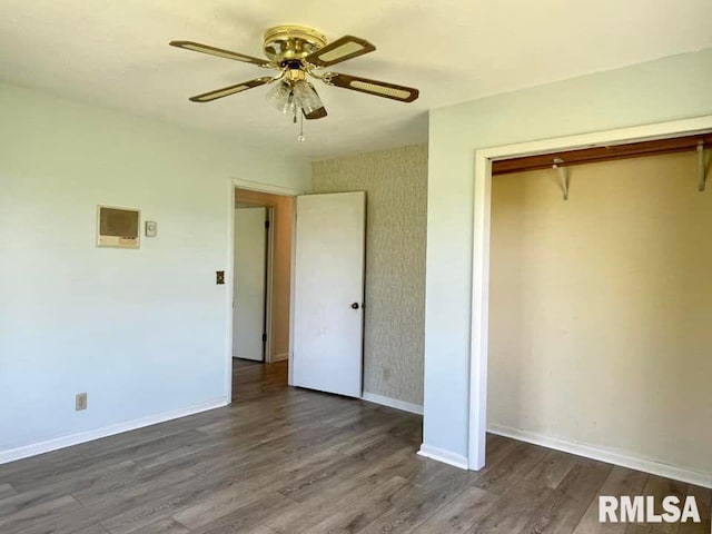 unfurnished bedroom featuring a closet, ceiling fan, and dark hardwood / wood-style floors