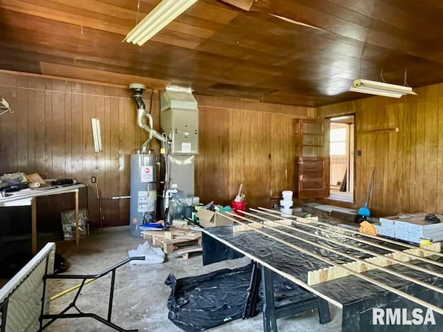 miscellaneous room featuring wooden ceiling, wood walls, and gas water heater