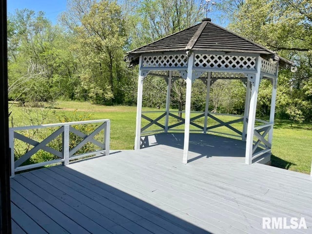 wooden terrace with a gazebo and a yard