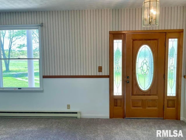 carpeted foyer entrance with baseboard heating and a wealth of natural light