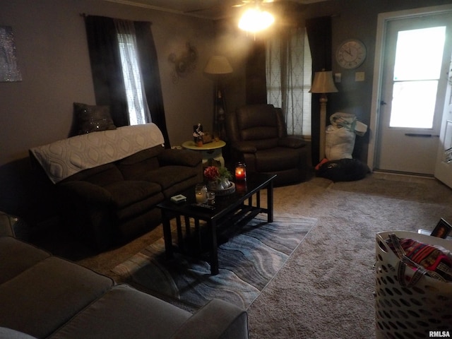 carpeted living room with ceiling fan