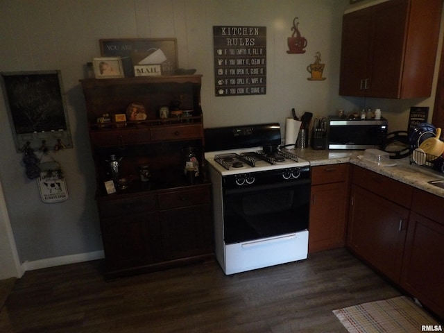 kitchen with dark hardwood / wood-style flooring and white electric range