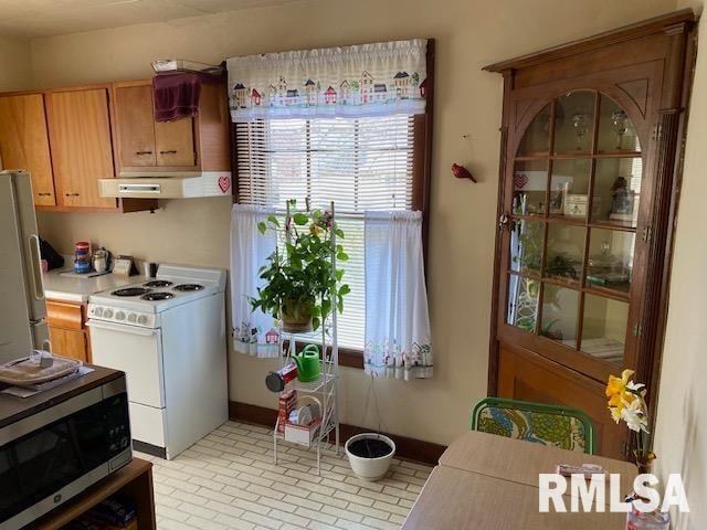 kitchen with appliances with stainless steel finishes and ventilation hood