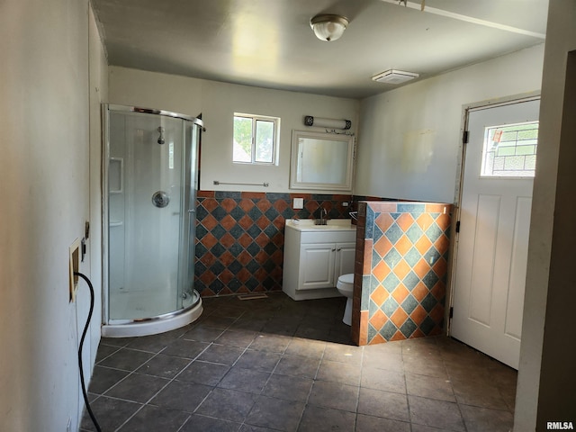 bathroom with tile patterned flooring, an enclosed shower, toilet, and vanity