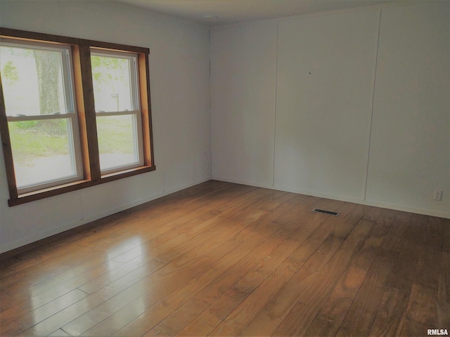 unfurnished room featuring hardwood / wood-style floors