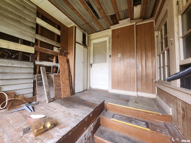 miscellaneous room featuring wood walls