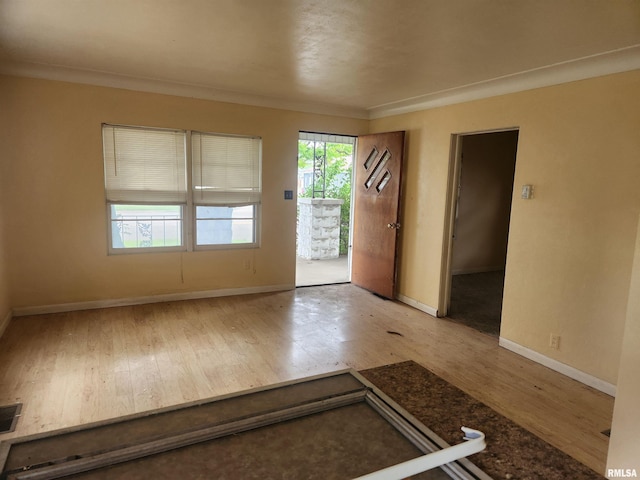 entrance foyer with light wood-type flooring and crown molding