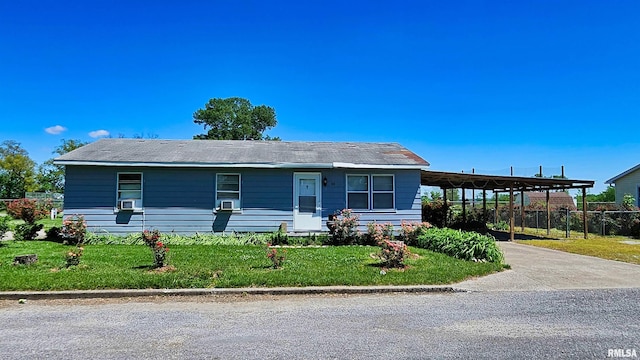99 Iroquois St, Mcclure, IL 62957 - ranch-style house featuring an attached carport, concrete driveway, and cooling unit
