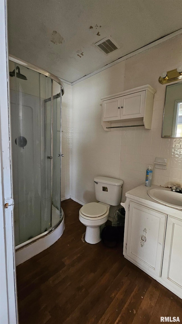 99 Iroquois St, Mcclure, IL 62957 - full bath with wood finished floors, a stall shower, toilet, and tile walls