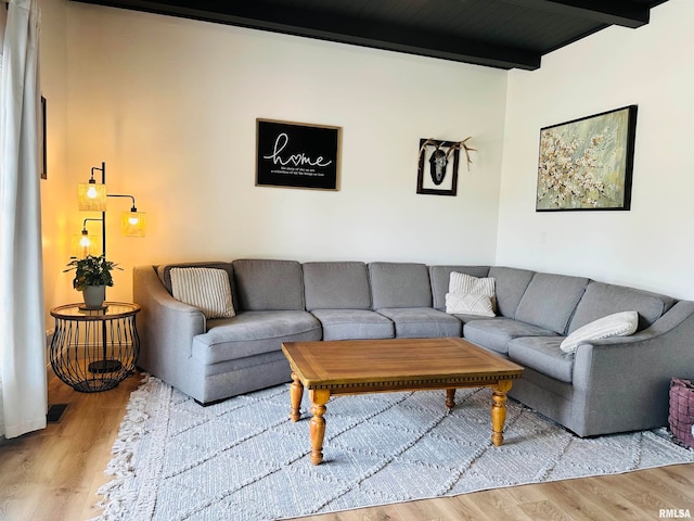 living room with beam ceiling, wooden ceiling, and hardwood / wood-style floors