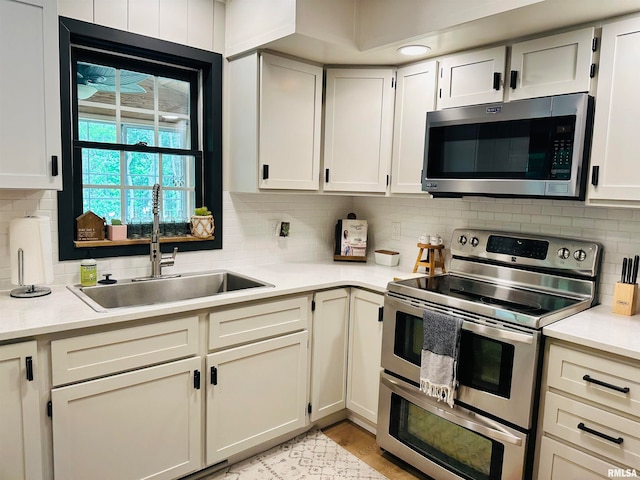 kitchen with sink, tasteful backsplash, and appliances with stainless steel finishes