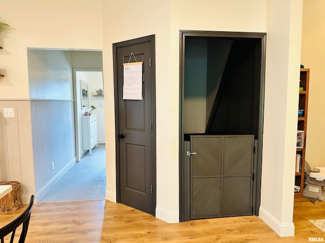 corridor featuring light hardwood / wood-style floors