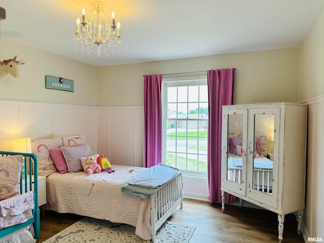 bedroom with an inviting chandelier and hardwood / wood-style flooring