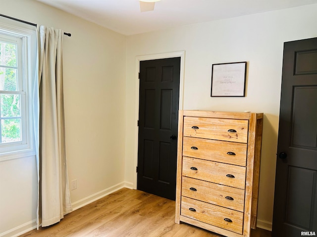 bedroom with ceiling fan and light hardwood / wood-style floors