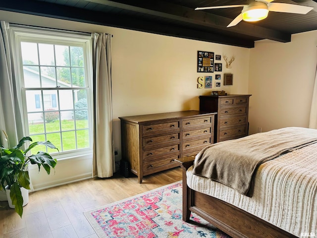 bedroom with beamed ceiling, ceiling fan, and light hardwood / wood-style floors