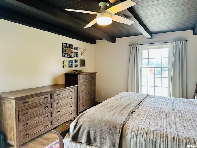 bedroom with beamed ceiling, light hardwood / wood-style floors, wood ceiling, and ceiling fan