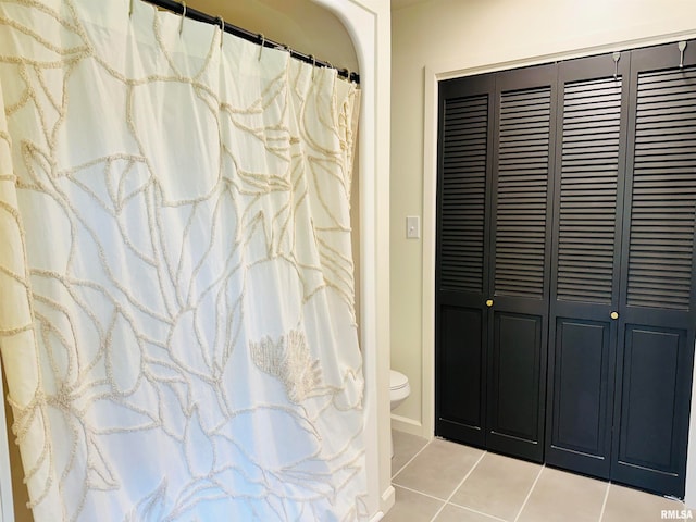 bathroom with tile floors and toilet