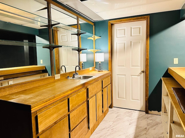 kitchen with wooden counters, sink, and light tile flooring