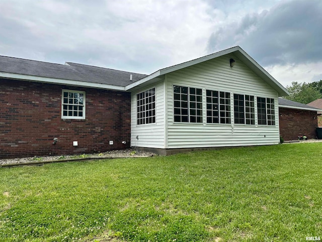 back of house with a lawn