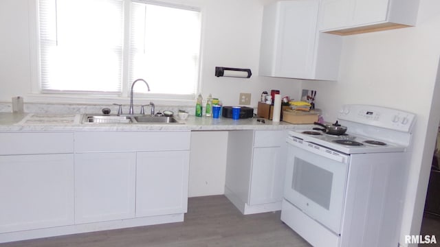 kitchen featuring white cabinetry, white electric range, sink, and a wealth of natural light