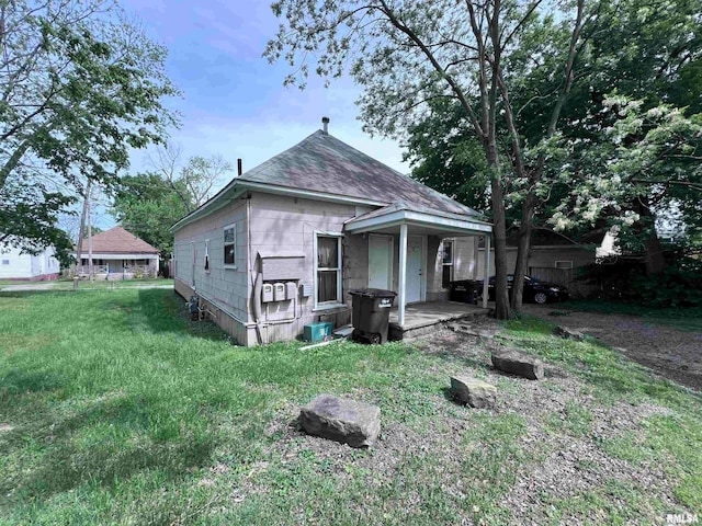 back of house with a lawn