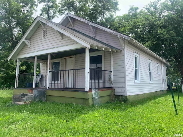 bungalow with a front yard and a porch