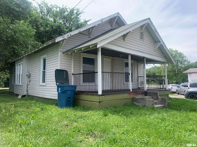 bungalow-style home with a porch and a front lawn