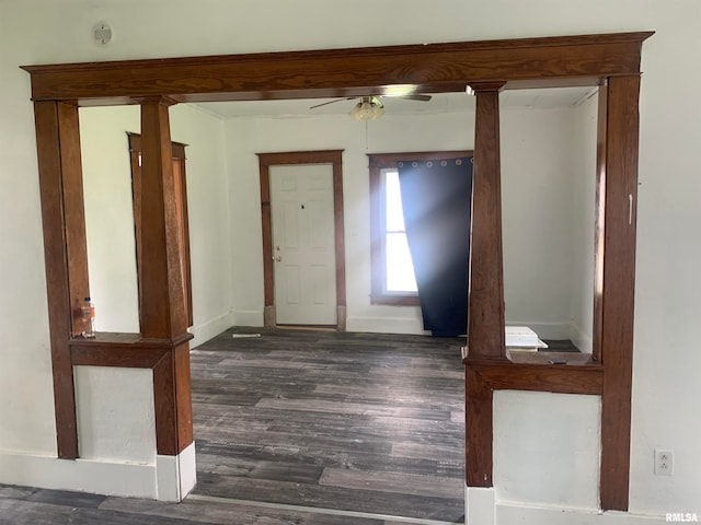 entryway featuring dark wood-type flooring, decorative columns, and ceiling fan