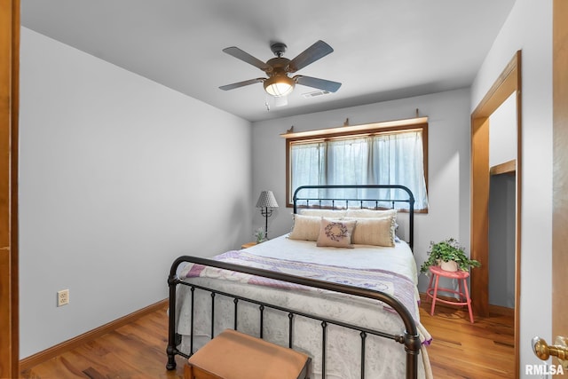 bedroom featuring wood-type flooring and ceiling fan