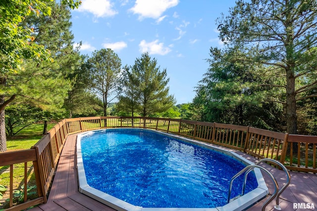 view of swimming pool with a wooden deck