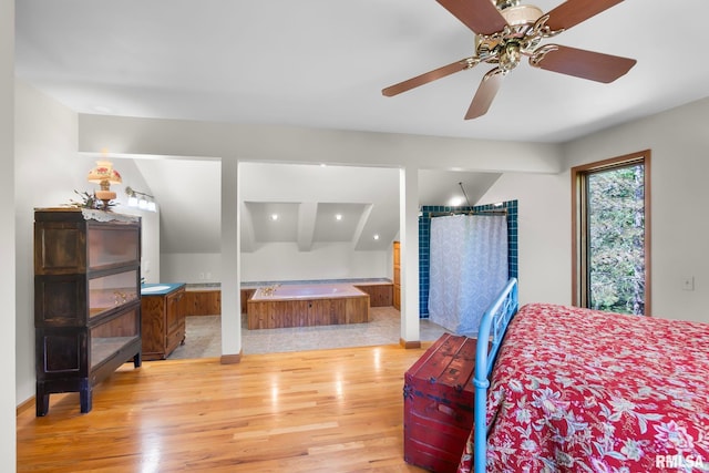 bedroom with beamed ceiling, hardwood / wood-style floors, and ceiling fan