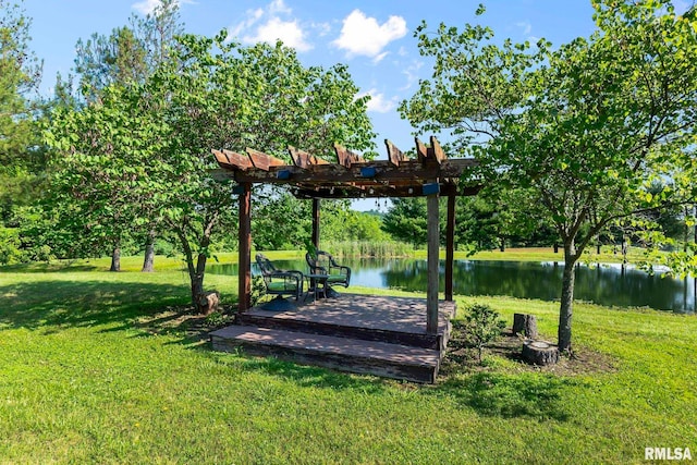 view of home's community with a pergola, a water view, and a lawn