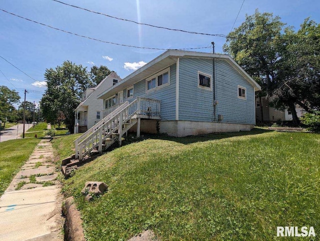 view of side of property with a lawn