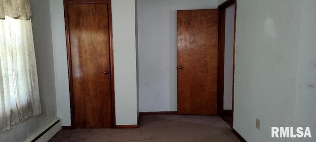 108 N Spencer St, Mounds, IL 62964 - hallway featuring carpet, a baseboard heating unit, baseboards, and plenty of natural light