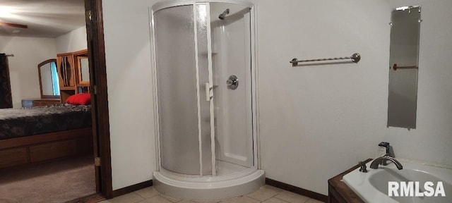 108 N Spencer St, Mounds, IL 62964 - bathroom with connected bathroom, a stall shower, a bath, tile patterned floors, and baseboards