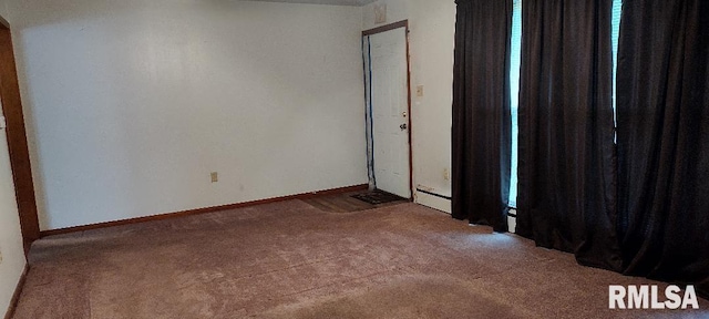 108 N Spencer St, Mounds, IL 62964 - carpeted empty room featuring baseboards and a baseboard heating unit